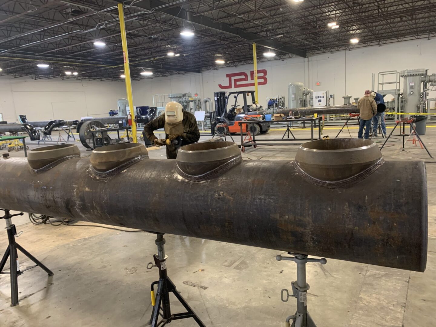 A large pipe sitting in the middle of an industrial area.