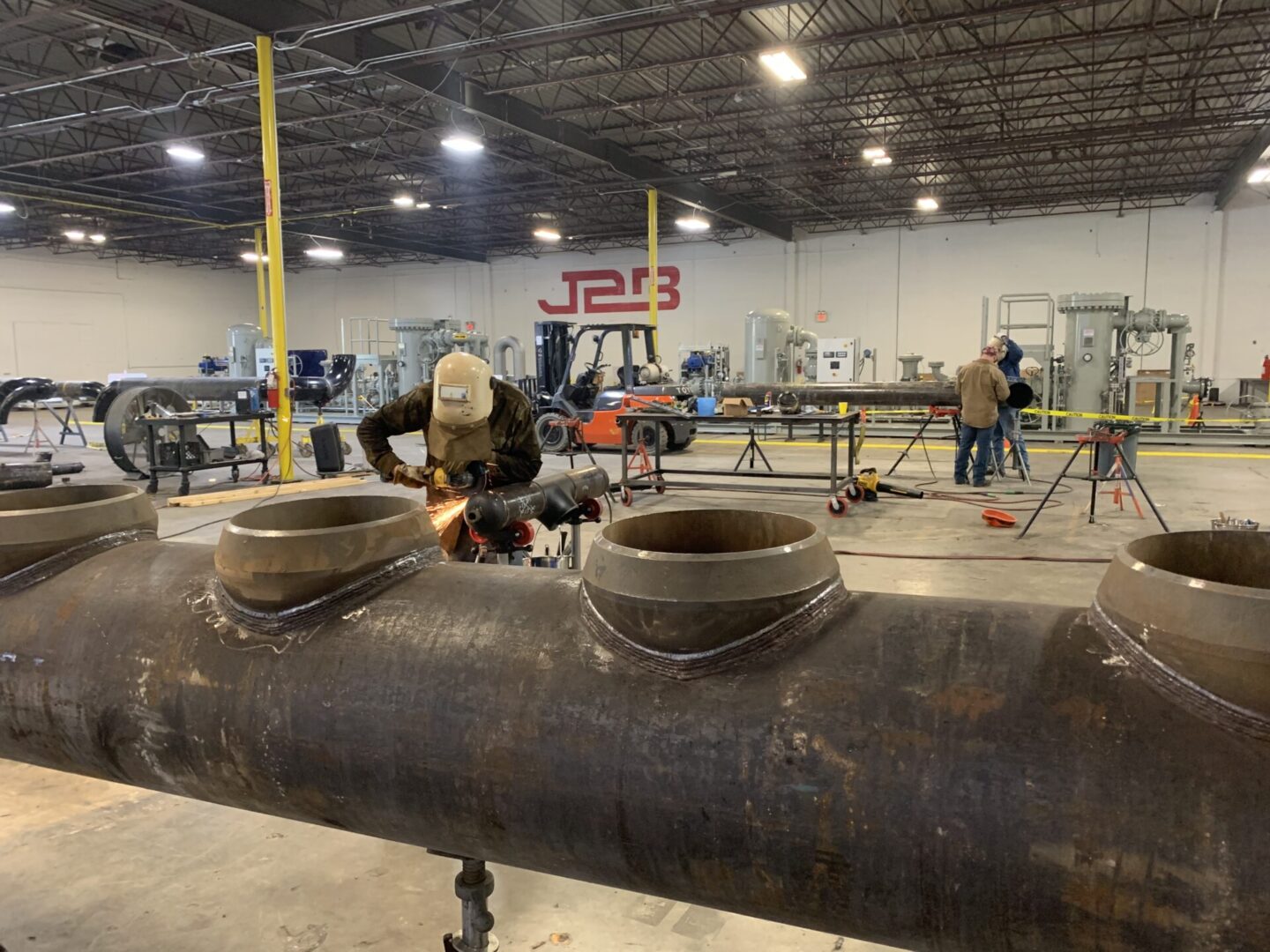 A man working on pipes in an industrial setting.