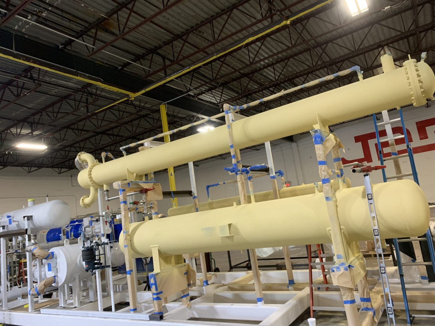 A large yellow pipe system in an industrial setting.