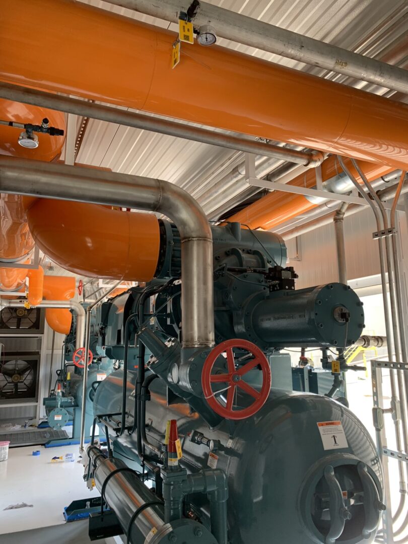 A large industrial type machine in an orange room.