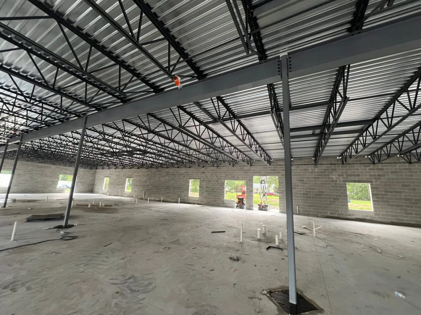 A large room with metal roof and walls.